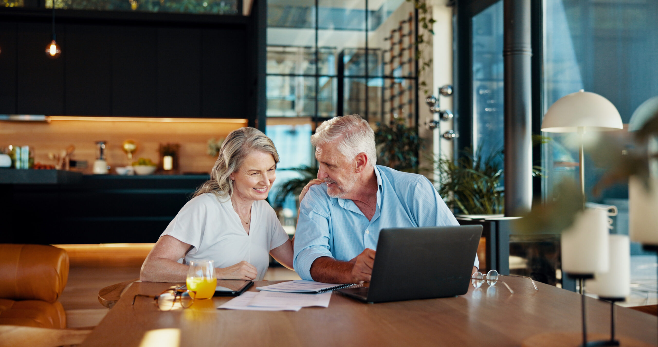 older wealthy couple in their kitchen discussing a QLAC Annuity