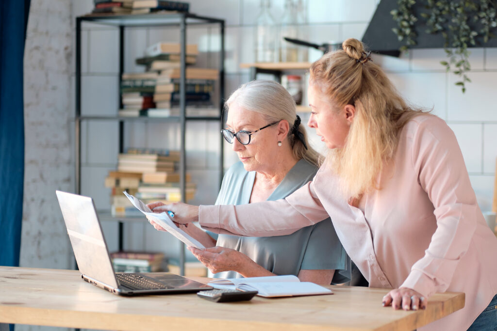 Mother and daughter looking online and comparing Medigap and Medicare Advantage plans.